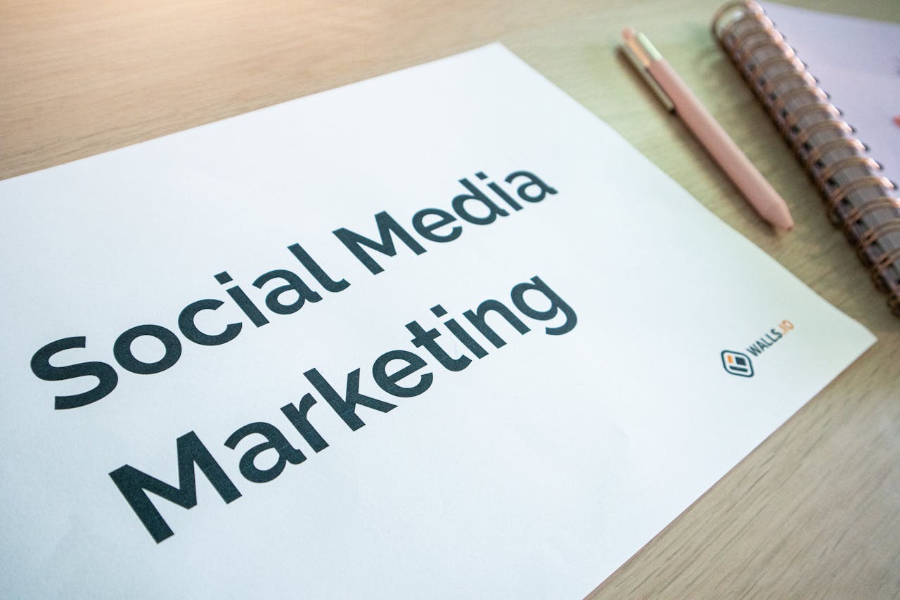 services-04 Close-up of a social media marketing document on a desk with a pen and notebook.