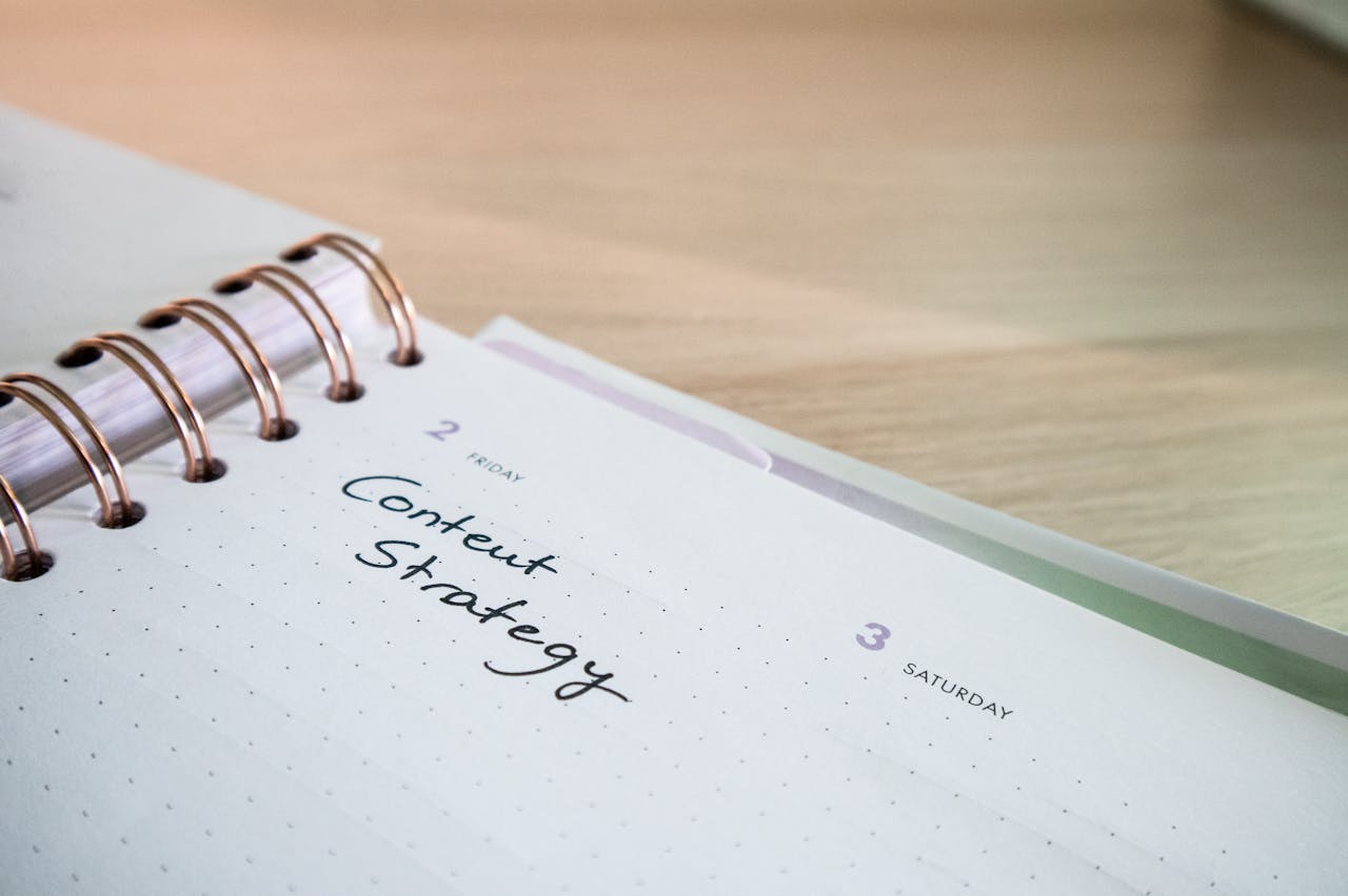 hero-img Close-up of a notebook page with Content Strategy written on it, ideal for business planning visuals.
