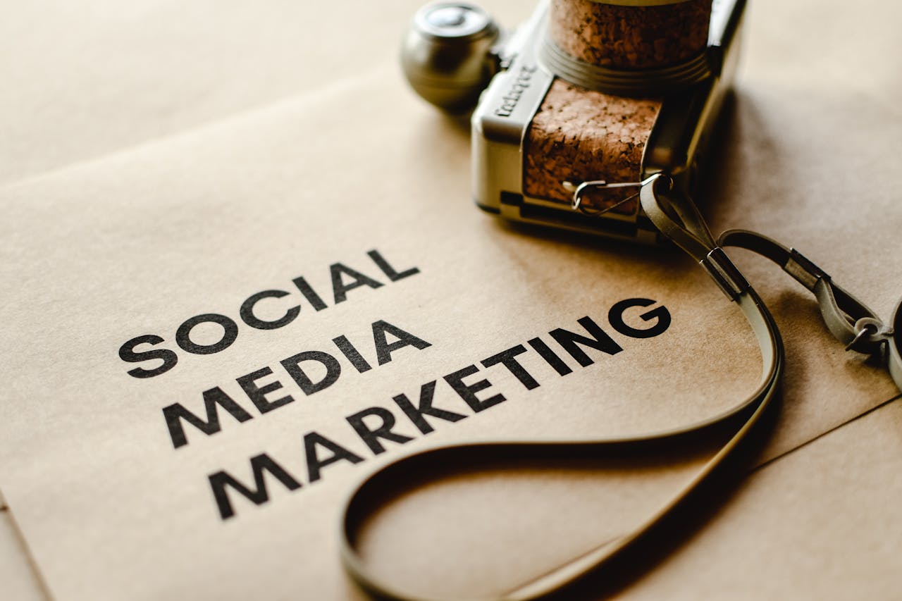 services-01 Close-up of a camera placed on brown paper with Social Media Marketing text, emphasizing digital marketing themes.